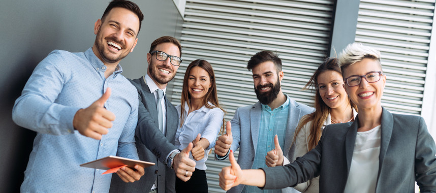 Business team celebrating a triumph with arms up in office